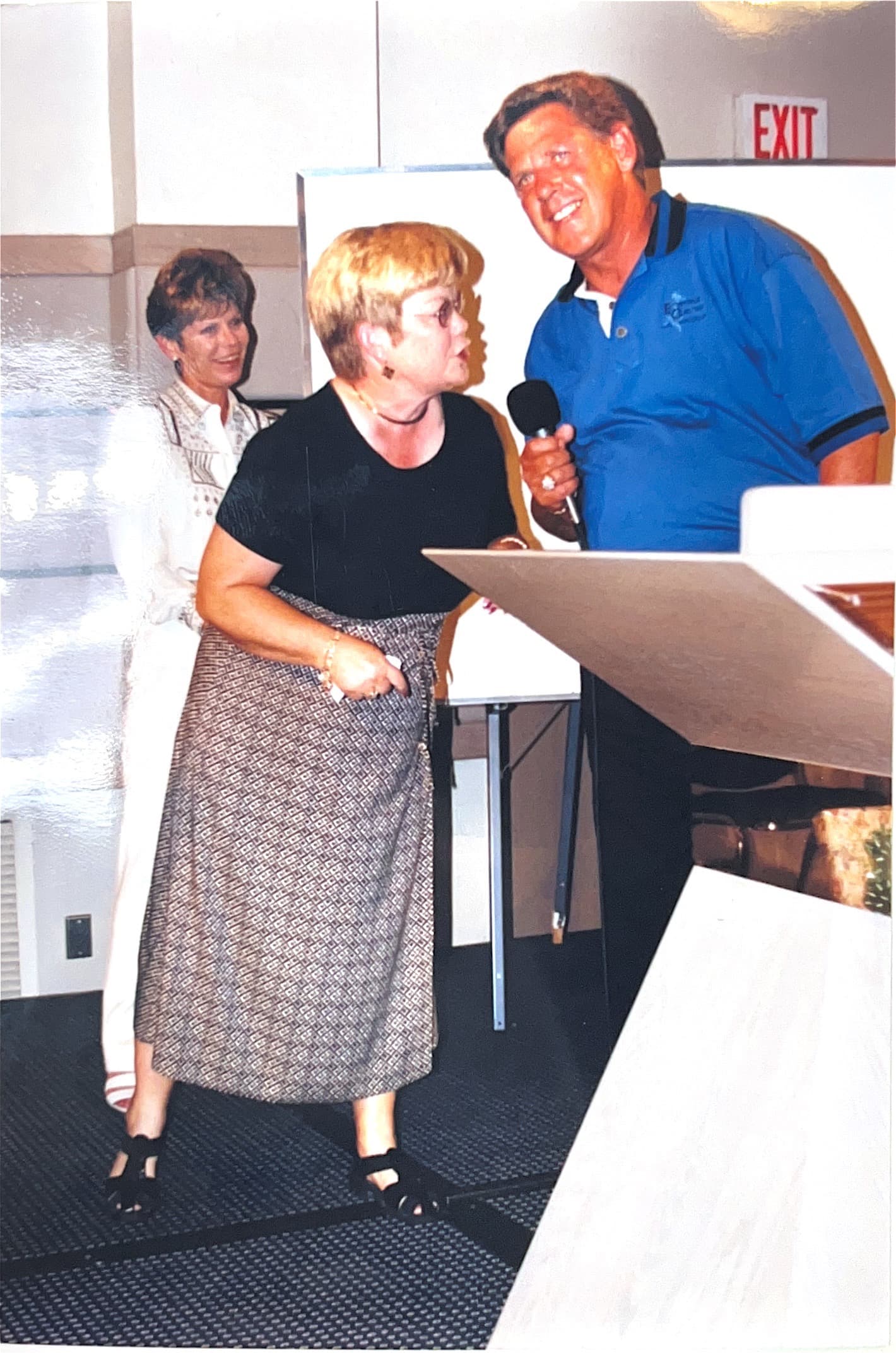Ron Puryear speaking at a leadership event with Georgia Lee nearby